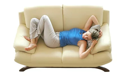 woman laying on couch protected with stain guard